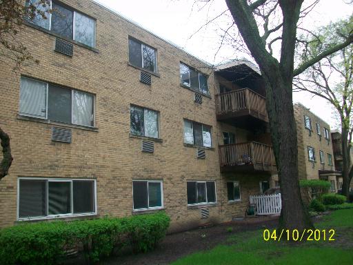 Front view of a three-story brick apartment building.