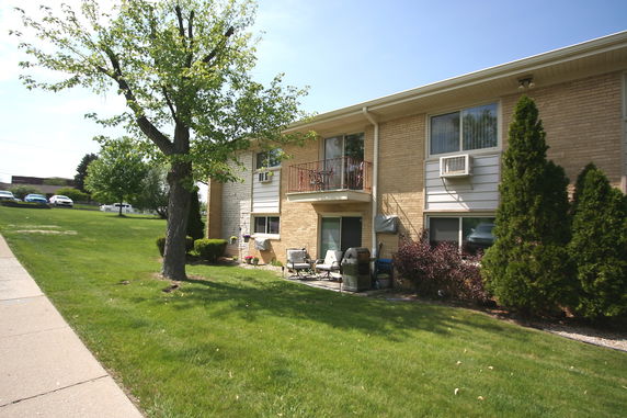 Front view of a two-story residential building with a small balcony.