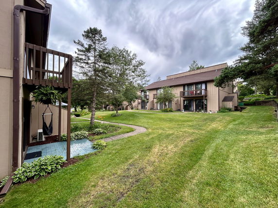 Front view of multiple two-story residential buildings with balconies.