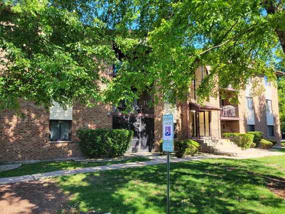 Front view of a multi-story brick apartment building.