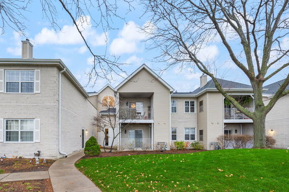 Front view of a multi-story residential building with balconies.