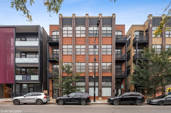 Front view of a multi-story building with modern architectural design.