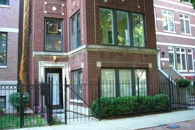 Front view of a brick multi-story residential building.