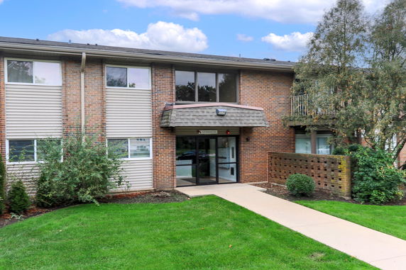 Front view of a two-story brick building with a covered entrance.