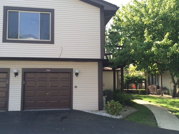 Front view of a two-story house with a single garage.