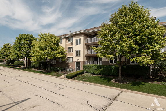 Front view of a multi-story residential building with balconies.