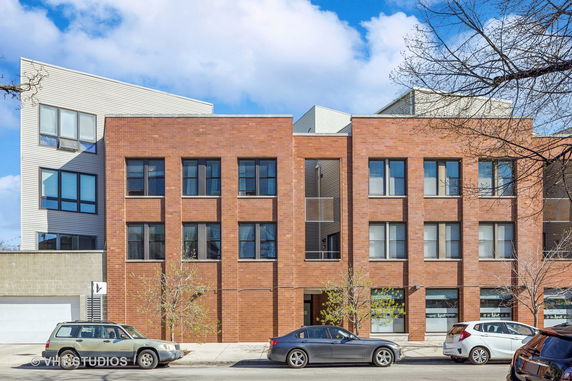 Front view of a three-story contemporary brick building.