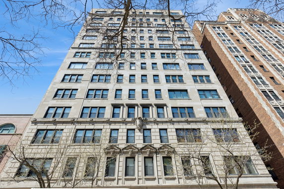 Front view of a multi-story building with numerous windows.
