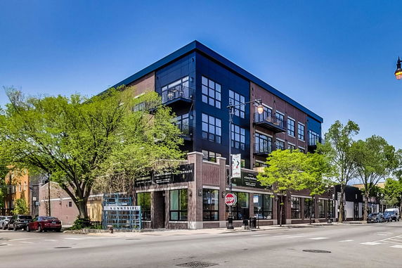Front view of a multi-story commercial building with large windows and balconies.