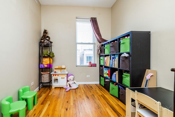 Room with shelves and toys arranged for children's play.