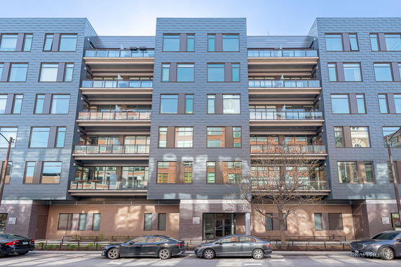 Front view of a modern multi-story apartment building.
