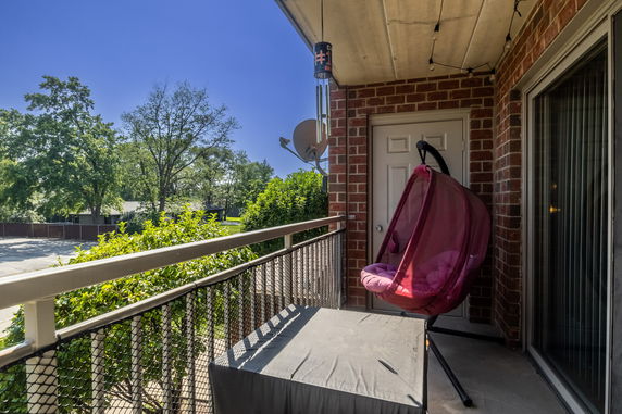 View from a house balcony looking at trees and surrounding area.