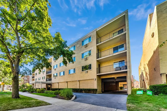 Front view of a multi-story apartment building with balconies.