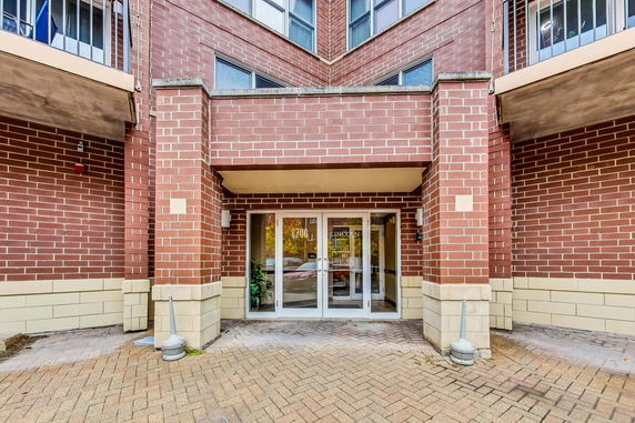 Entrance of a brick building with glass doors.