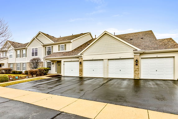 Front view of a two-story house with garages.