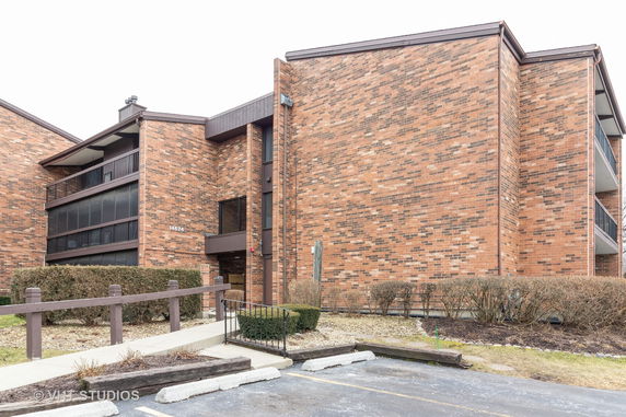 Front view of a multi-story brick apartment building.