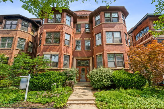 Front view of a multi-story brick apartment building.