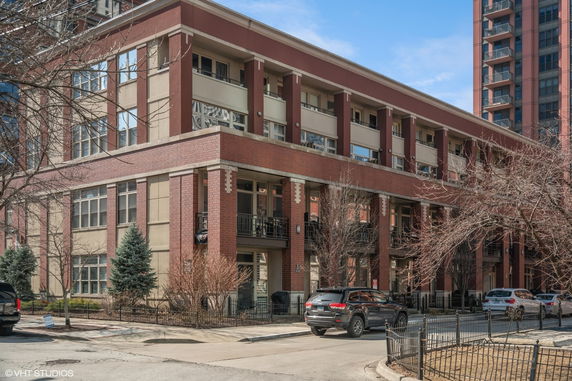 Front view of a multi-story building with a brick facade.
