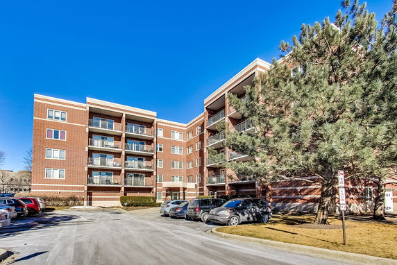 Front view of a multi-story brick apartment building.
