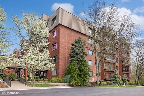 Front view of a multi-story brick building with balconies.