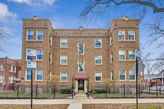 Front view of a three-story brick apartment building.