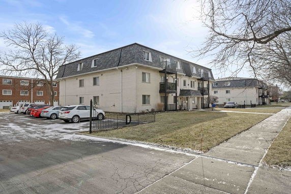Front view of a multi-story residential building with balconies.