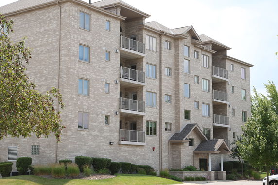 Front view of a multi-story apartment building with balconies.