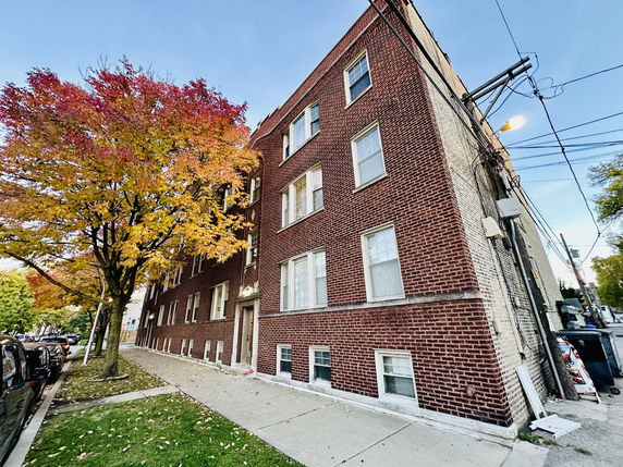 Front view of a multi-story brick building.