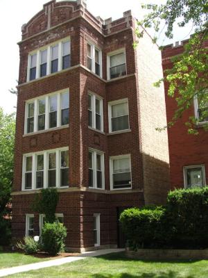 Front view of a multi-story brick apartment building.