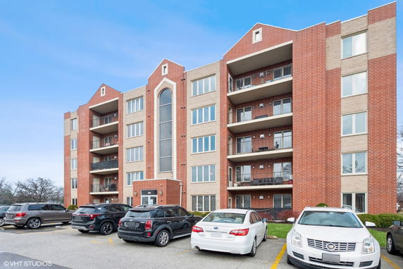 Front view of a multi-story apartment building with balconies.