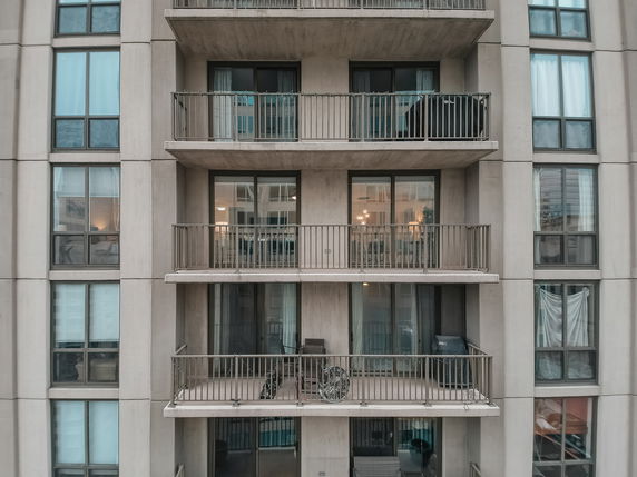 Front view of a multi-story building with balconies.