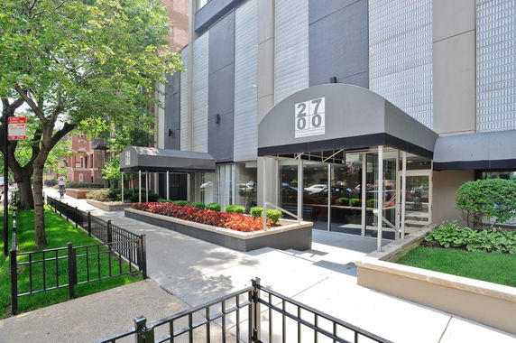 Front view of a building with a modern entrance and canopy.