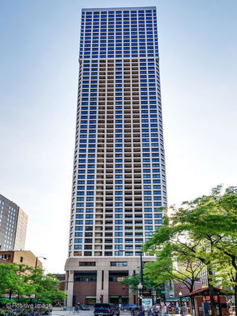 Front view of a high-rise building with a grid-like facade.