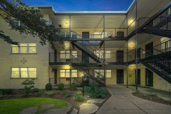 Front view of a residential building with multiple staircases and balconies.