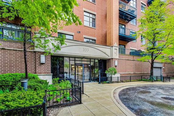 Front view of a brick apartment building entrance.