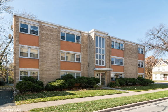Front view of a three-story brick apartment building.
