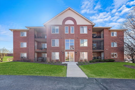 Front view of a three-story brick apartment building