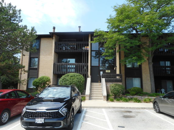 Front view of a multi-story residential building with balconies.