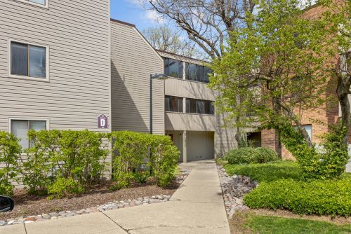 Front view of a multi-story building with beige siding.