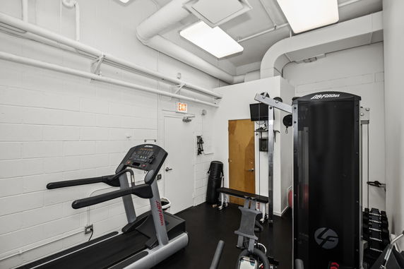Interior view of a fitness room with gym equipment.