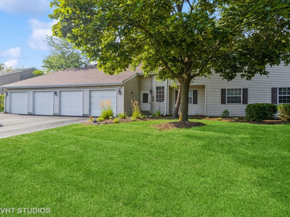 Front view of a single-story house with a three-car garage.