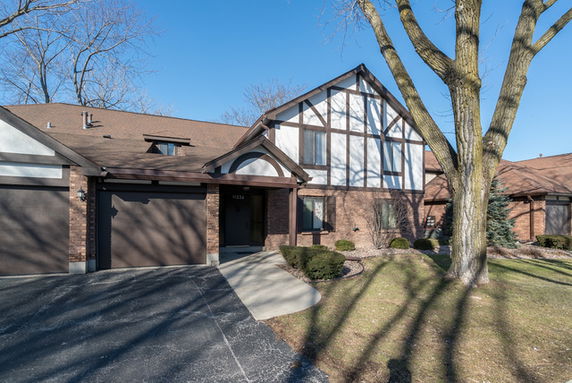 Front view of a two-story house with a garage.