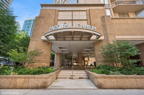 Front view of a multi-story building entrance with architectural features.