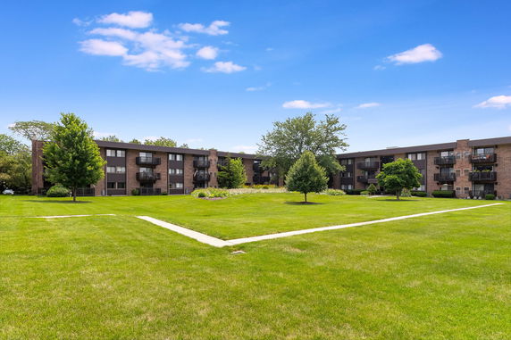 Front view of a three-story brick apartment building.