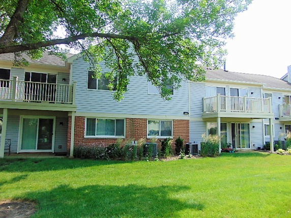 Front view of a two-story residential building with balconies.
