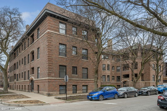 Front view of a multi-story brick apartment building.