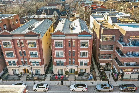 Front view of brick residential buildings with multiple stories.
