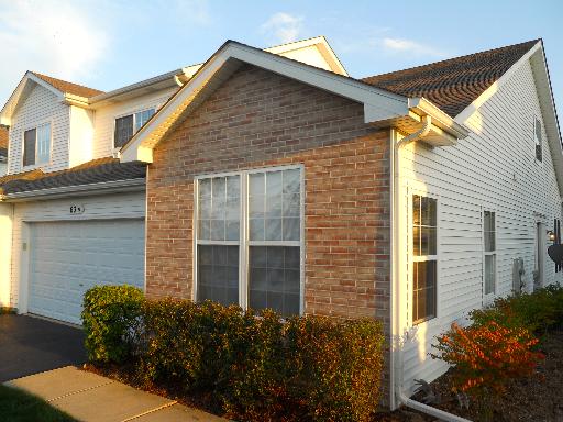 Front view of a two-story house with a brick and siding exterior.