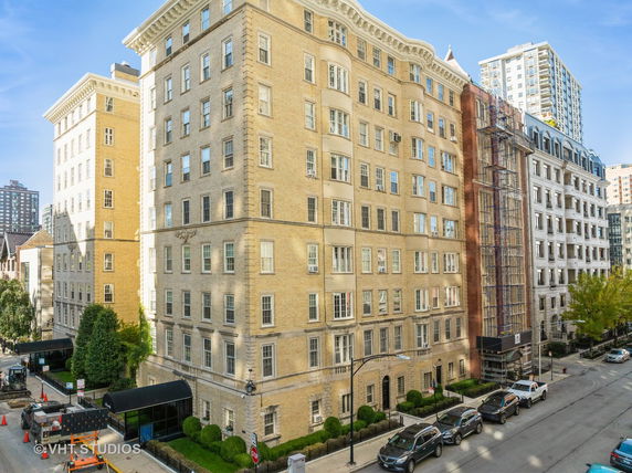 Front view of a multi-story apartment building with brick exterior.