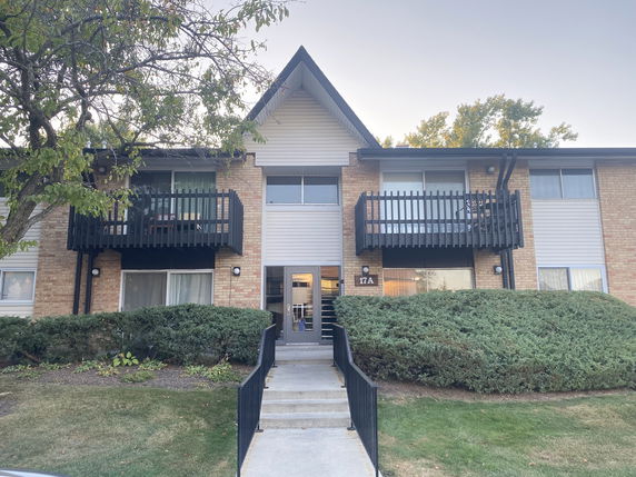 Front view of a two-story apartment building with balconies.